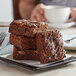 A stack of David's Cookies Double Fudge Chunk brownies on a white plate.
