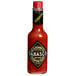 A close up of a TABASCO® Scorpion Hot Sauce bottle with a label.