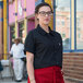 A woman wearing a black Uncommon Chef cook shirt.