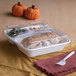 A clear compostable plastic lid designed to fit a 3-compartment take-out container.