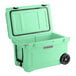 A seafoam green CaterGator outdoor cooler with wheels.