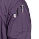 A close-up of the pocket on a purple Uncommon Chef 3/4 Length Sleeve Chef Coat.