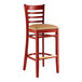 A Lancaster Table & Seating mahogany wood bar stool with a light brown cushion.