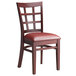 A Lancaster Table & Seating wooden chair with a burgundy vinyl cushion.