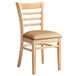 A Lancaster Table & Seating wooden restaurant chair with a light brown vinyl cushion.