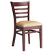 A Lancaster Table & Seating wood chair with light brown vinyl seat and back.