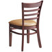 A Lancaster Table & Seating mahogany wood chair with light brown vinyl seat and ladder back.