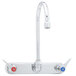 A chrome T&S wall mount faucet with two red and blue knobs.