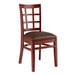 A Lancaster Table & Seating wooden chair with dark brown vinyl seat.