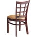 A Lancaster Table & Seating mahogany wood chair with a light brown cushion on the seat and a window back.