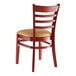 A Lancaster Table & Seating wooden chair with a light brown vinyl seat and ladder back.
