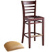 A Lancaster Table & Seating mahogany wood bar stool with a light brown vinyl seat.