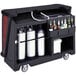 A Cambro portable bar cart with bottles and a soda gun on it.