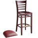 A Lancaster Table & Seating mahogany wood bar stool with a burgundy vinyl seat.