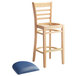 A Lancaster Table & Seating wooden ladder back bar stool with a navy vinyl seat on it.