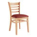 A Lancaster Table & Seating wooden chair with a burgundy vinyl seat.