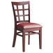 A Lancaster Table & Seating mahogany wood window back chair with a burgundy vinyl seat.