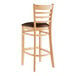 A Lancaster Table & Seating wooden bar stool with a dark brown cushion.