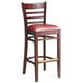 A Lancaster Table & Seating mahogany wood bar stool with a burgundy vinyl seat.