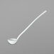 A white ladle with long handle.
