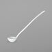 A white ladle with a long handle.