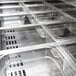 A Turbo Air refrigerated sandwich prep table with a row of plastic containers with lids inside.