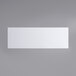 A white rectangular object on a grey surface.