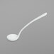 A white ladle with a long handle.