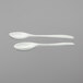 Two white G.E.T. Enterprises server spoons.