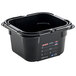 An Araven black plastic food pan on a counter with a label.