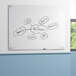 A white Quartet magnetic glass dry erase board with text on it.