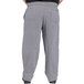 A person wearing Uncommon Chef houndstooth chef pants with a pocket.