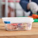 A person using an Araven translucent plastic food pan to cut vegetables.