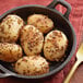 A pan of food with brown seeds and sprinkles on top.