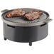 A Cal-Mil round chafer alternative with meat on a grill.
