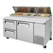 A Turbo Air stainless steel pizza prep table with drawers.