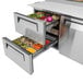 A Turbo Air stainless steel pizza prep table with two open drawers.