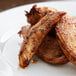 A plate of chicken wings seasoned with Regal Cajun Spice on a table.