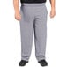 A person wearing Uncommon Chef houndstooth chef pants.