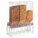A Cal-Mil white triple cereal dispenser with clear plastic containers full of different kinds of cereal.