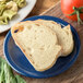 A slice of bread on a Carlisle blue melamine bread and butter plate.