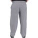 Uncommon Chef houndstooth chef pants with a pocket being worn by a person with a black shirt.