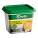 A close up of a Knorr Seafood Bouillon Base container with a green lid.