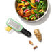 A bowl of stir fry with OXO grater next to it.
