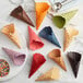 A group of colorful Konery lavender waffle cones on a white plate.
