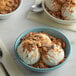 A bowl of ice cream with BUTTERFINGER® crumbles and chocolate.