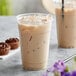 A close up of a glass of Tazo Chai Tea Latte with ice.