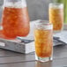 A glass of iced tea on a table.