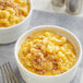 Two bowls of Knorr macaroni and cheese with a fork.
