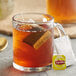 A glass mug of Lipton Earl Grey tea with a tea bag in it.